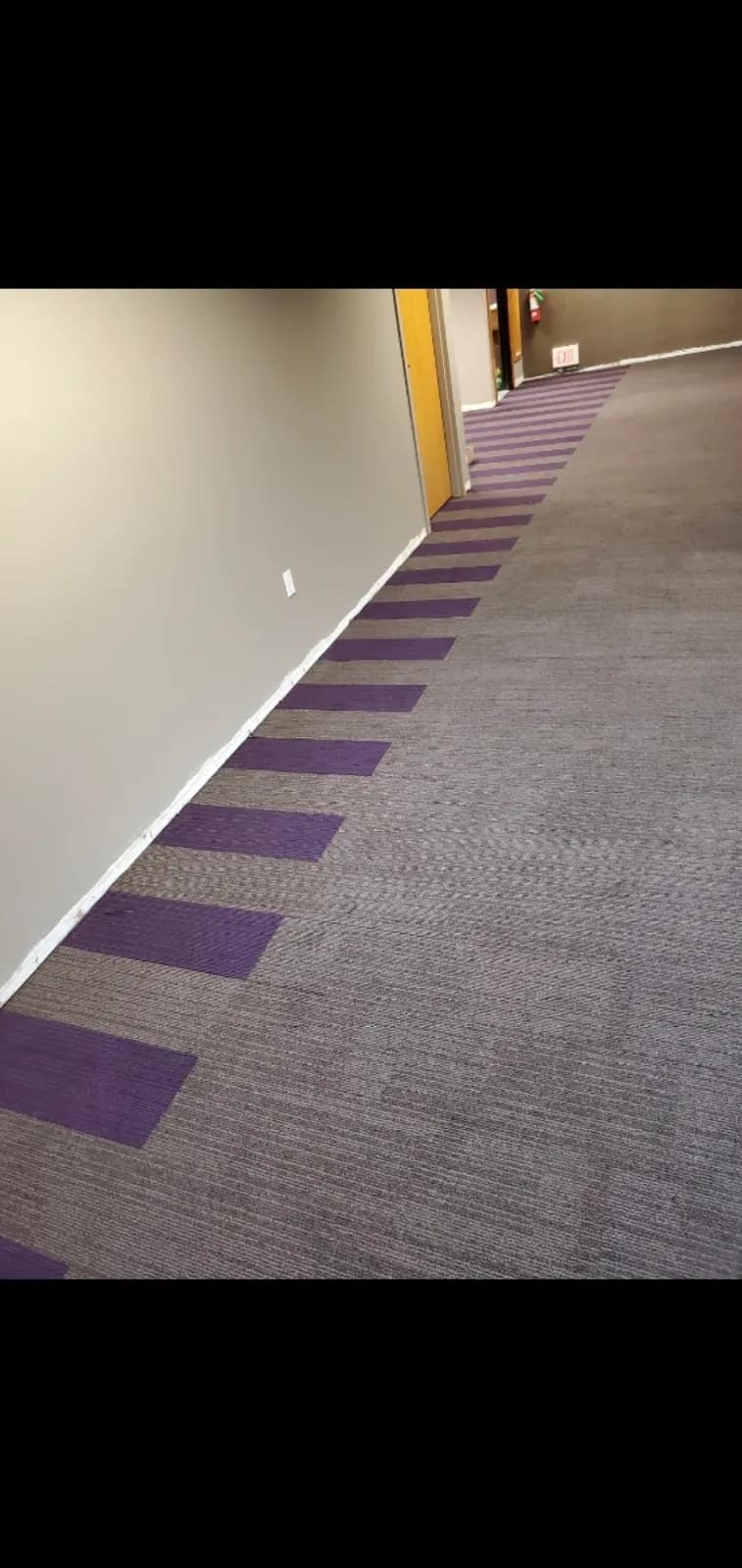 Commercial carpet tile in a hallway, installed by Threshing Floors