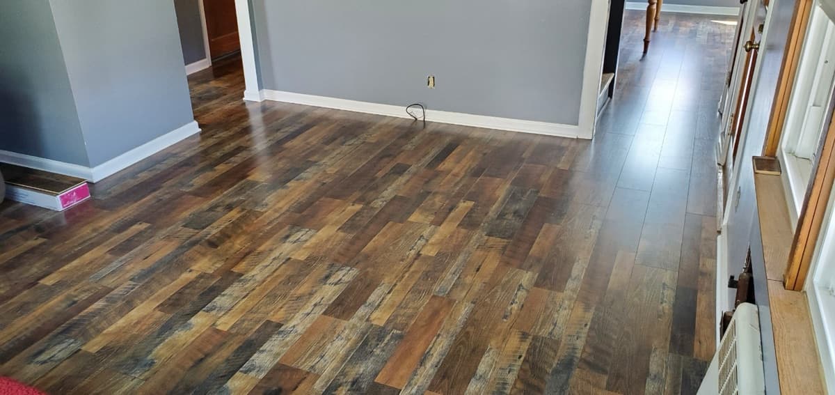 Dark rustic hardwood plank flooring in a living room — installed by Threshing Floors