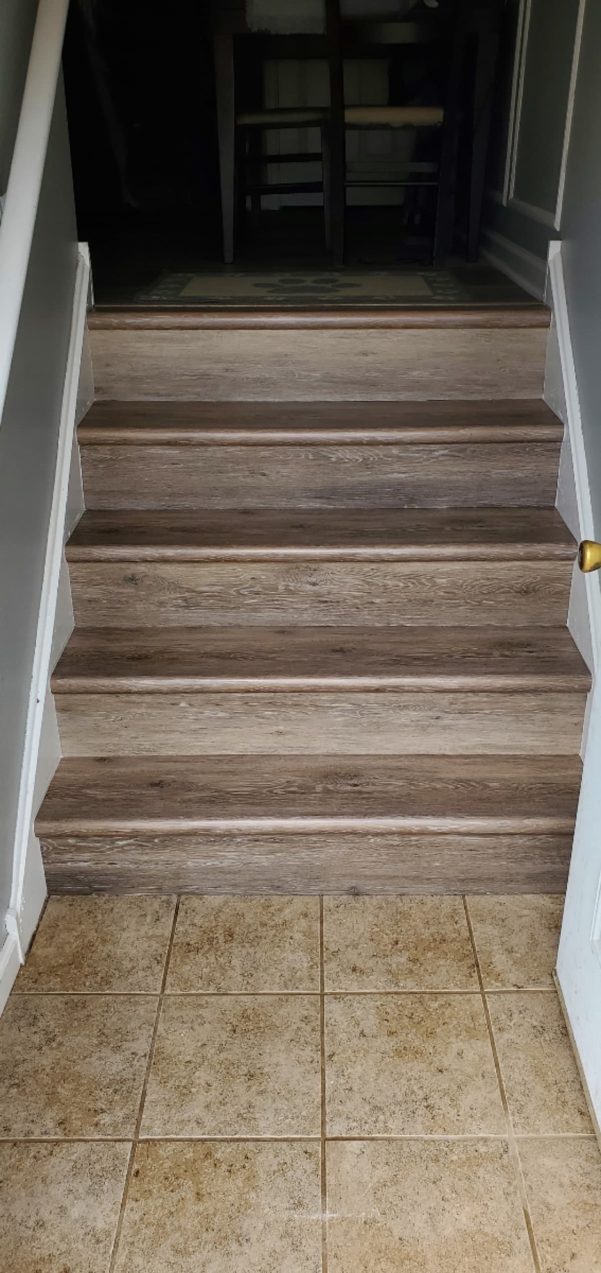 LVP stair treads with tile-to-vinyl transition — installed by Threshing Floors