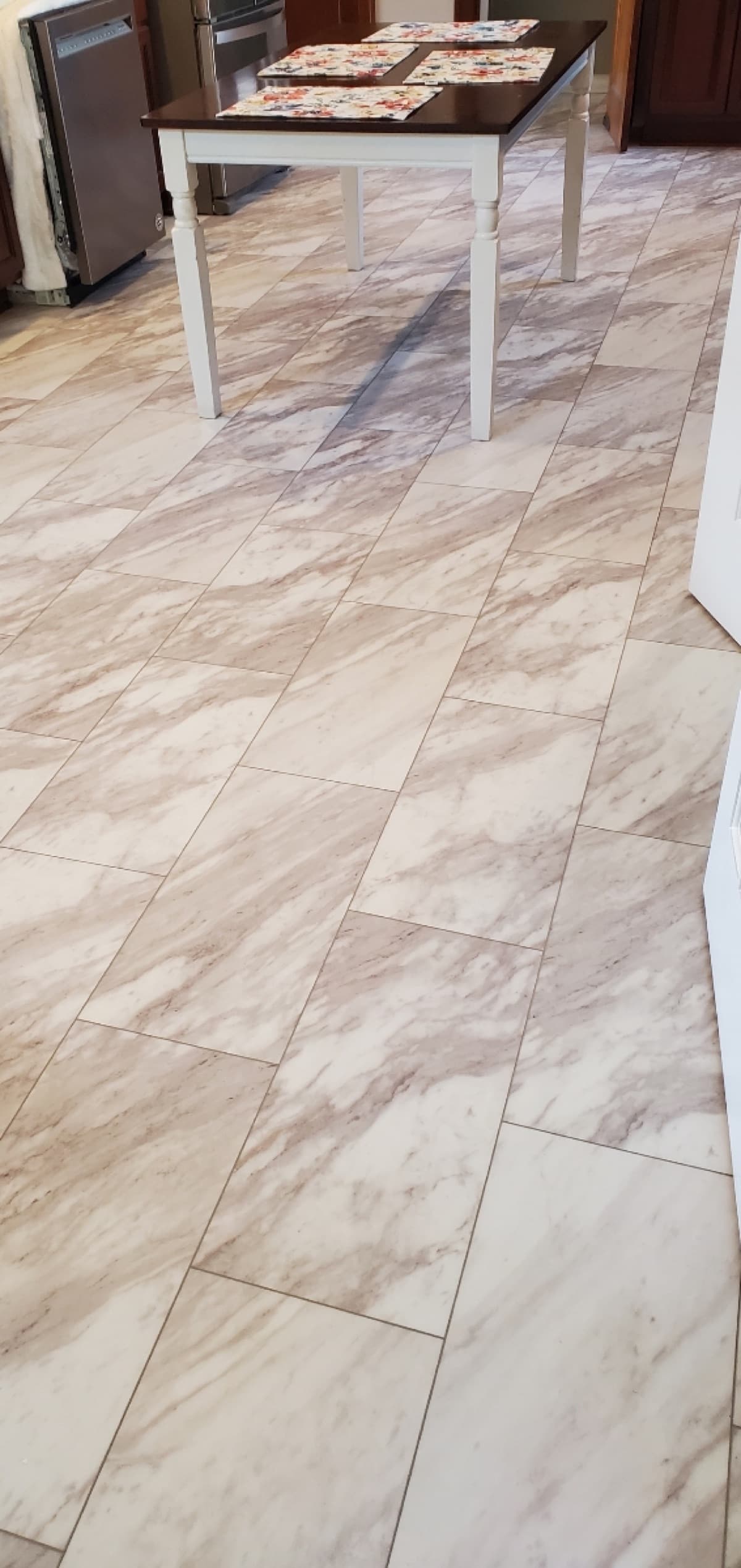 Marble-look tile flooring in a residential kitchen — installed by Threshing Floors