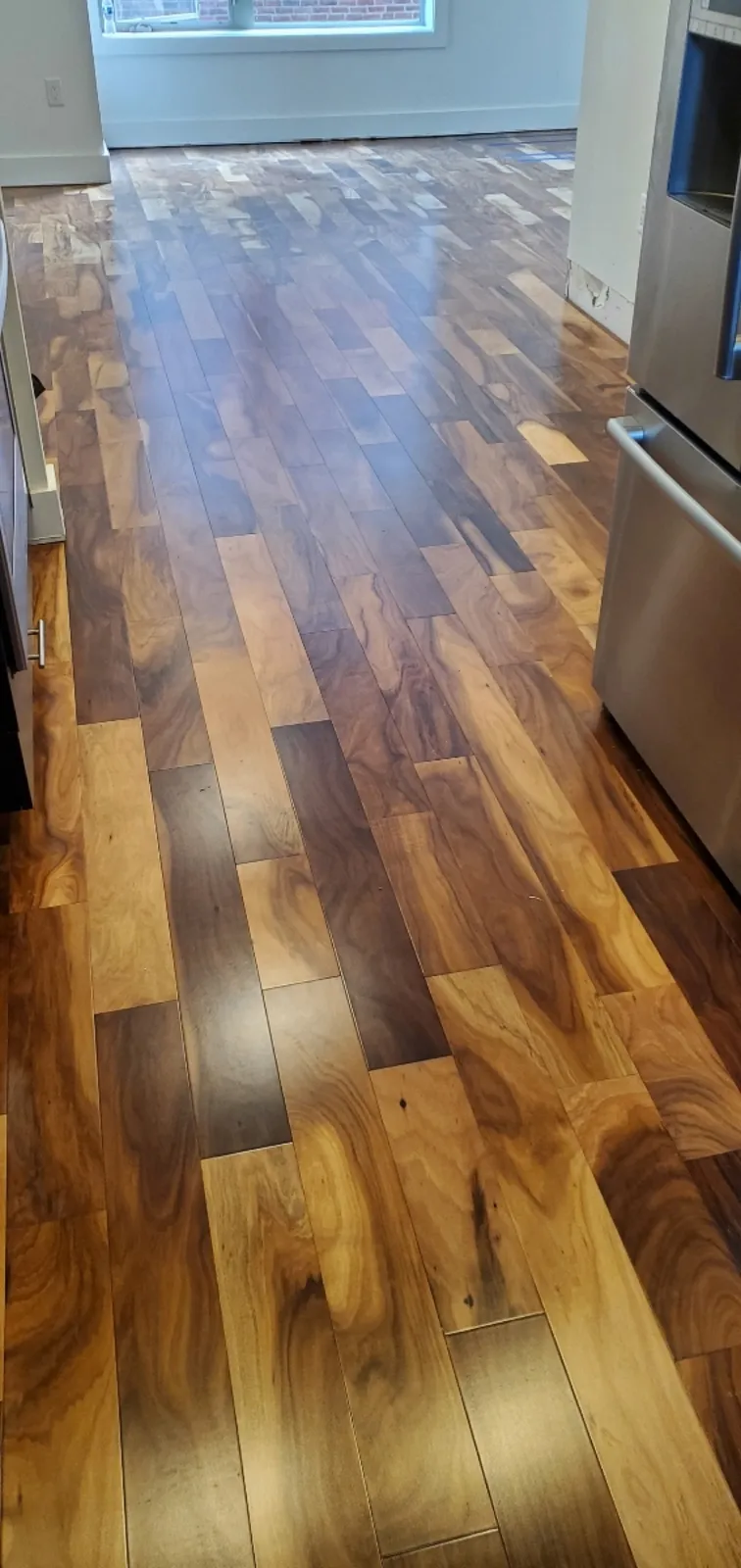 Glossy exotic hardwood flooring in a residential kitchen — installed by Threshing Floors